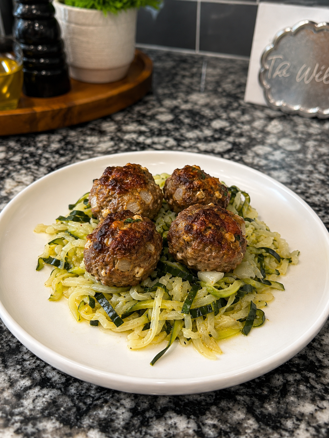 new cover photo zucchini noodles with meatballs on countertop